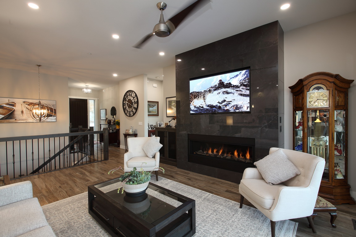 Beautiful photo of living room with greyish black slate fireplace.