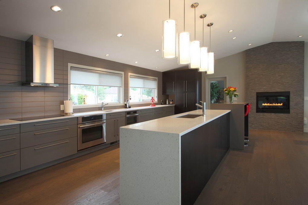 Photo of kitchen in Carlton residence with gas fireplace in the background.