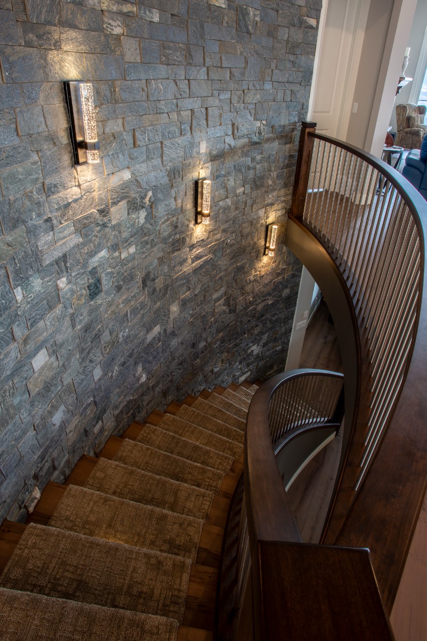 Photo of lit cultured stone stairwell.