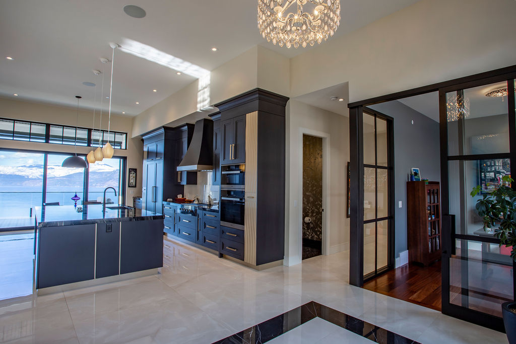 Photo of kitchen overlooking mountain scape and doorway into office.